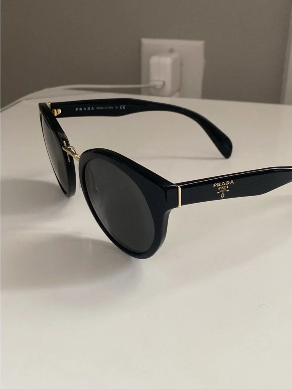 Prada Black Round Sunglasses with Gold Detailing